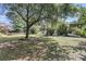 Large backyard with mature trees, patio, deck, and garden area offers ample outdoor living space at 1761 Old Military Rd, Charleston, SC 29412
