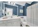 Bathroom featuring a vanity, mirror, toilet, and shower with blue accents at 1761 Old Military Rd, Charleston, SC 29412