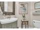 Charming bathroom featuring a rustic wood-framed mirror and stylish decor at 1761 Old Military Rd, Charleston, SC 29412