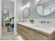 Stylish bathroom with double sinks, wood cabinets, and modern lighting at 1761 Old Military Rd, Charleston, SC 29412