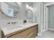 Stylish bathroom with double sinks, wood cabinets, and modern lighting at 1761 Old Military Rd, Charleston, SC 29412