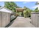Long driveway and carport offer ample parking, complemented by fencing and greenery for added privacy at 1761 Old Military Rd, Charleston, SC 29412
