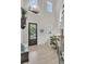Bright, open foyer with a dark wood door, a staircase, and decor with plants at 1761 Old Military Rd, Charleston, SC 29412