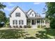 Charming two-story home featuring a spacious porch, manicured lawn, and classic architectural details at 1761 Old Military Rd, Charleston, SC 29412