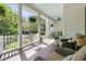 Relaxing porch featuring comfortable seating, elegant columns, and hanging ferns with blue painted ceiling at 1761 Old Military Rd, Charleston, SC 29412
