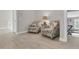 Well-lit hallway with two armchairs and a table at 1761 Old Military Rd, Charleston, SC 29412
