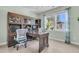 Bright home office with wooden desk and storage, and lots of natural light at 1761 Old Military Rd, Charleston, SC 29412
