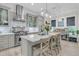 Well-lit kitchen with a large center island with seating, stainless appliances, and hanging pendant lights at 1761 Old Military Rd, Charleston, SC 29412