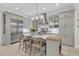 Bright kitchen with a large central island with seating, stainless appliances, and custom gray cabinets at 1761 Old Military Rd, Charleston, SC 29412