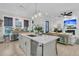 Open-concept kitchen flowing into the living room, featuring a large island and modern appliances at 1761 Old Military Rd, Charleston, SC 29412