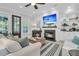 Inviting living room features a fireplace, built-in shelving, and access to the outdoor patio through glass door at 1761 Old Military Rd, Charleston, SC 29412