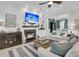 Cozy living room features a fireplace, TV, and built-in shelving; connects to another sitting area at 1761 Old Military Rd, Charleston, SC 29412