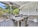 Covered patio offers dining area, outdoor ceiling fan, and a screened view of the landscaped backyard at 1761 Old Military Rd, Charleston, SC 29412