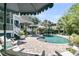 Backyard pool area featuring mature landscaping, lounge chairs, and relaxing outdoor entertainment at 1761 Old Military Rd, Charleston, SC 29412