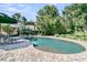Relaxing pool area surrounded by lush landscaping and lounge chairs; great for summer fun at 1761 Old Military Rd, Charleston, SC 29412