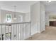 Bright foyer featuring a white staircase with a decorative chandelier at 1761 Old Military Rd, Charleston, SC 29412