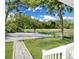 Scenic backyard features a gravel area and lawn, complemented by lush trees and blue skies at 1915 Quitman St, North Charleston, SC 29405