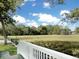 Picturesque backyard with green grass and marsh, seen from a porch with white railings at 1915 Quitman St, North Charleston, SC 29405