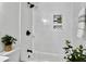 Bright bathroom showcasing a tiled shower and tub with stylish black fixtures and accents at 1915 Quitman St, North Charleston, SC 29405