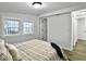 Bright bedroom featuring a striped bedspread, light hardwood floors, and white trim windows at 1915 Quitman St, North Charleston, SC 29405