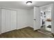 Bedroom featuring light hardwood floors and white trim closet doors leading to the kitchen at 1915 Quitman St, North Charleston, SC 29405