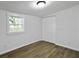 Bedroom featuring light hardwood floors, a closet, and a window with white trim at 1915 Quitman St, North Charleston, SC 29405
