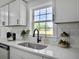 Updated kitchen with subway tile backsplash, stainless steel sink, and bright natural lighting at 1915 Quitman St, North Charleston, SC 29405