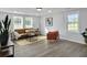Inviting living room featuring a leather sofa, cozy rug, and ample natural light at 1915 Quitman St, North Charleston, SC 29405