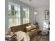 Cozy living room features a leather sofa and bright windows, creating an inviting space at 1915 Quitman St, North Charleston, SC 29405