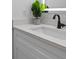 A pristine bathroom sink featuring a quartz countertop, a sleek matte-black faucet, and stylish green plant at 1989 Groveland Ave, North Charleston, SC 29405