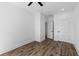 This spacious bedroom features wood-look flooring and bright white trim at 1989 Groveland Ave, North Charleston, SC 29405