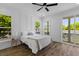 A bedroom boasts modern decor, beautiful windows, and a sliding glass door leading to a balcony at 1989 Groveland Ave, North Charleston, SC 29405