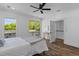 A bedroom features a sliding glass door leading to a balcony, views from two windows, and a ceiling fan at 1989 Groveland Ave, North Charleston, SC 29405