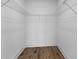 An empty closet features wood floors, base trim, and wire shelving, awaiting to store your personal belongings at 1989 Groveland Ave, North Charleston, SC 29405
