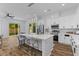 Modern kitchen boasts an island with seating, stainless steel appliances, and a seamless transition to the outdoor space at 1989 Groveland Ave, North Charleston, SC 29405