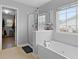 Bathroom showcases a deep soaking tub, walk-in shower, and a window for natural light and ventilation at 200 Commencement Blvd, Ladson, SC 29456
