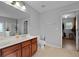 Elegant bathroom featuring double sink vanity with wood cabinets, large mirror, and tile flooring at 200 Commencement Blvd, Ladson, SC 29456