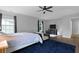 Bright bedroom with ceiling fan, windows, and hardwood floors is enhanced by a stylish area rug at 200 Commencement Blvd, Ladson, SC 29456