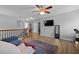 Bonus room featuring wood floors, ceiling fan, and flat screen TV at 200 Commencement Blvd, Ladson, SC 29456