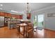Light-filled dining area featuring hardwood floors, modern chandelier, and seamless transition to outdoor space at 200 Commencement Blvd, Ladson, SC 29456