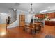 Spacious dining area adjacent to kitchen with hardwood floors, ample seating, and modern chandelier at 200 Commencement Blvd, Ladson, SC 29456
