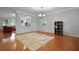 Open dining room with hardwood floors, chandelier, natural light, and easy flow to the kitchen at 200 Commencement Blvd, Ladson, SC 29456