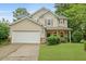 Charming two-story home boasts manicured lawn, a two-car garage, and inviting front porch at 200 Commencement Blvd, Ladson, SC 29456