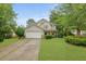 Attractive two-story home with lush green lawn, two car garage and covered front porch at 200 Commencement Blvd, Ladson, SC 29456