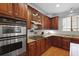 Kitchen features cherry cabinets, granite countertops, stainless appliances, and a window over the sink at 200 Commencement Blvd, Ladson, SC 29456