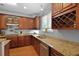 Features of this kitchen include granite counters, stainless appliances, and wood cabinets with wine storage at 200 Commencement Blvd, Ladson, SC 29456