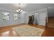 Inviting living room with hardwood floors, decorative rug, chandelier, and ample natural light at 200 Commencement Blvd, Ladson, SC 29456