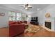 Bright living room featuring fireplace, hardwood floors, ceiling fan, and comfortable furnishings at 200 Commencement Blvd, Ladson, SC 29456