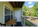 Balcony view featuring a wooden table and chairs, with scenic view of the surrounding palm trees at 2011 N Highway 17 # 1400P, Mount Pleasant, SC 29466