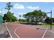 Community basketball court with lights, pond, fountain, and picnic tables in the background at 2011 N Highway 17 # 1400P, Mount Pleasant, SC 29466